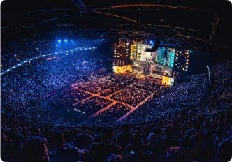 Player on stage in front of a stadium crowd